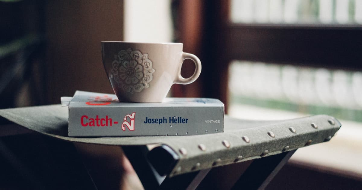 A coffee cup resting on a book in morning light, suggesting calm and clarity